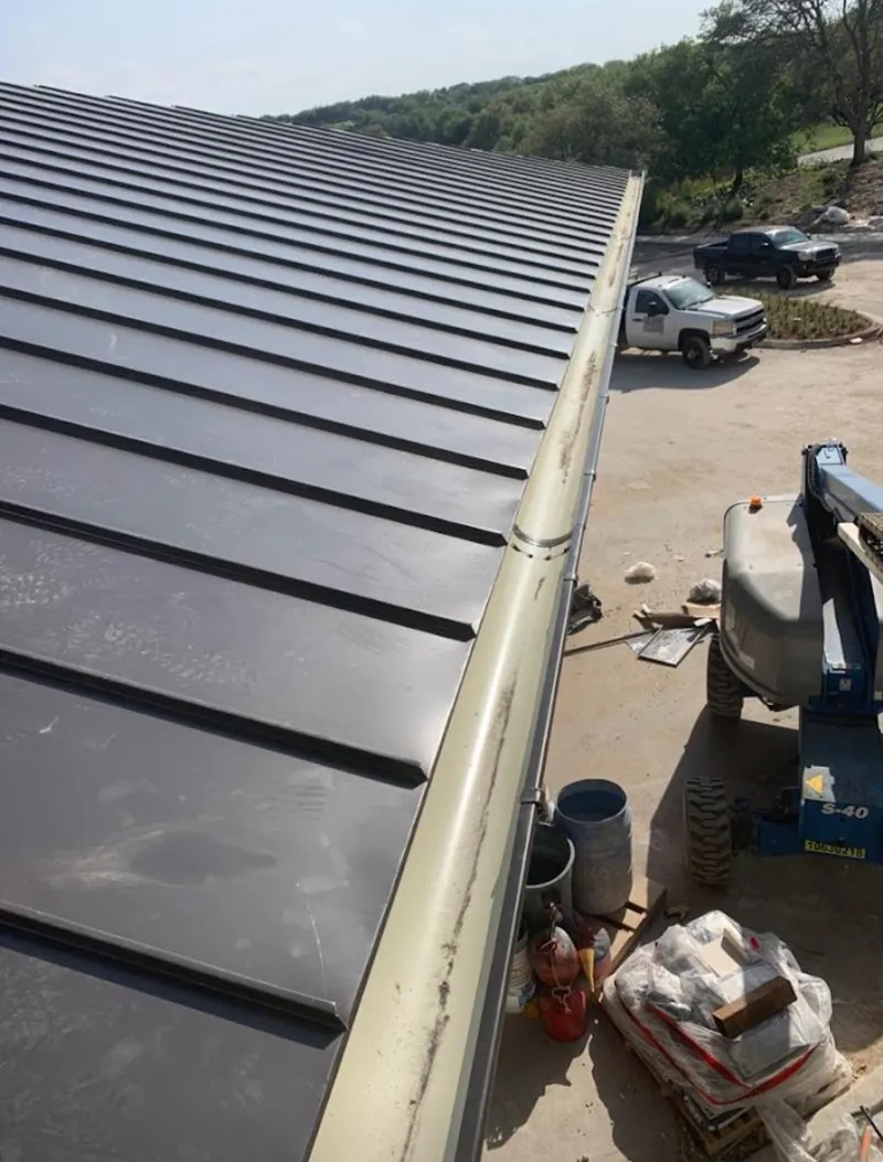 Standing seam panel and gutter detail on a metal roofing jobsite in Folsom